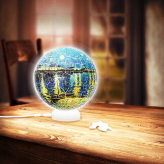 A Starry Night Over the Rhone Sphere Light puzzle on a wooden table.