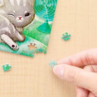 A person is solving a Forever Blue puzzle by putting the pieces together.